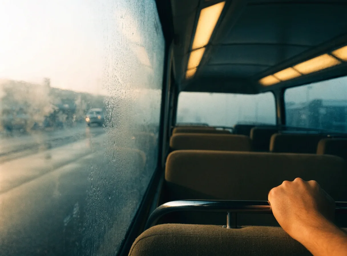 View through the fogged glass door of an airport shuttle bus