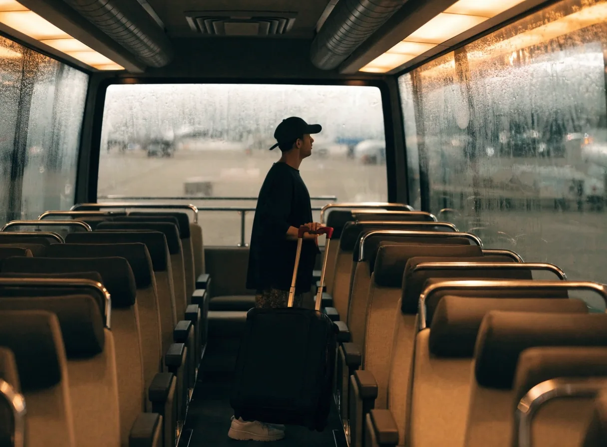 Interior of an airport shuttle bus with fogged windows and warm overhead lighting